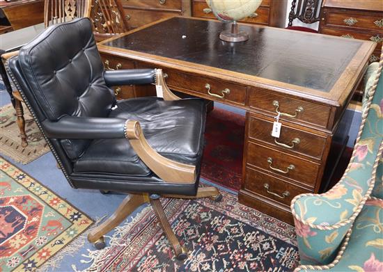 A late Victorian oak pedestal desk, bears Howard and Son stamp and plaque, together with a contemporary black W.150cm